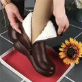 Retro British style flat boots with cowhide upper, side zipper, and metal decorative accents on a low tube silhouette.