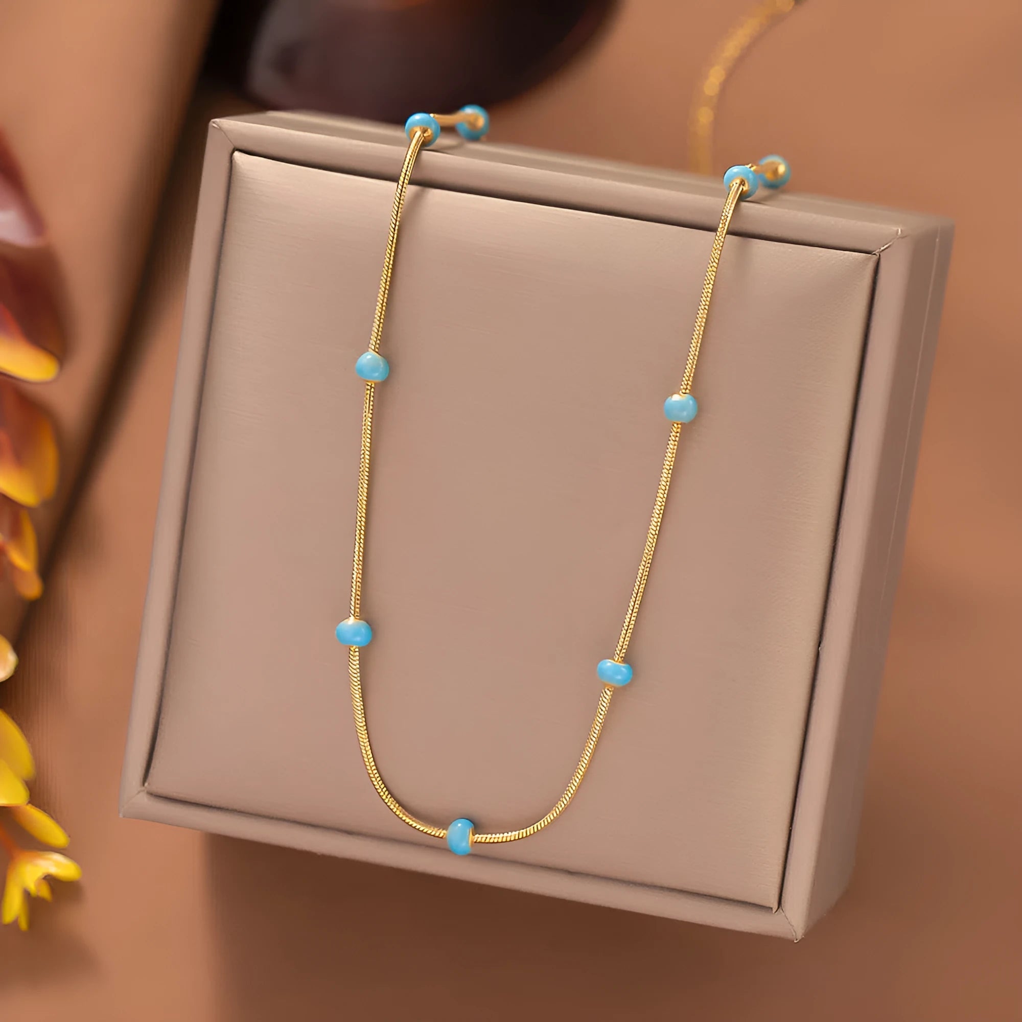Titanium steel ball drop glaze necklace in green pearl gold, clavicle length, on model