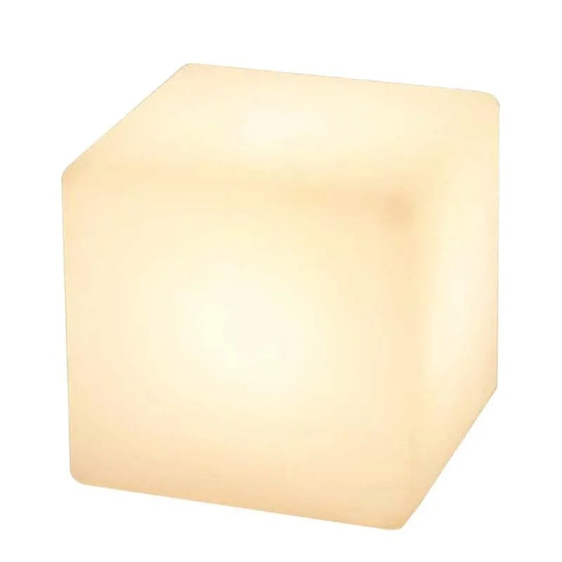 Square LED cube stool light in garden setting showing modern design with lighting