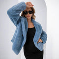Women's rose red loose short faux fur coat with regular sleeves on a hanger.