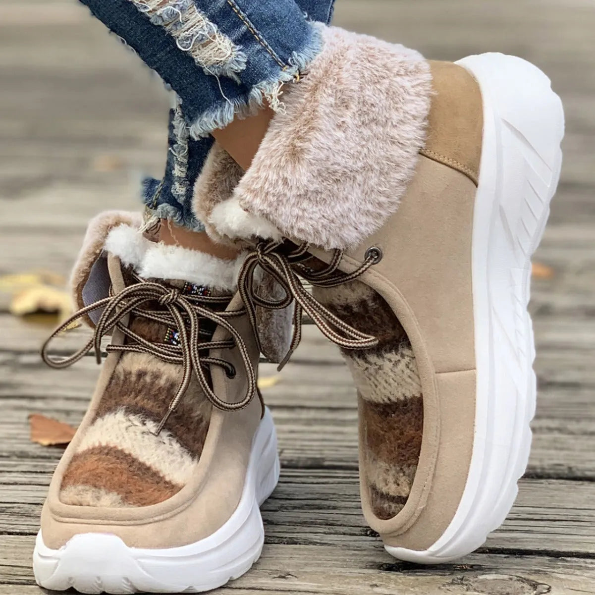 Women's beige lace-up snow boots with suede upper and thick rubber sole on white background