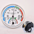 Indoor wall thermometer with plastic black shell and black plastic pointer on a wall