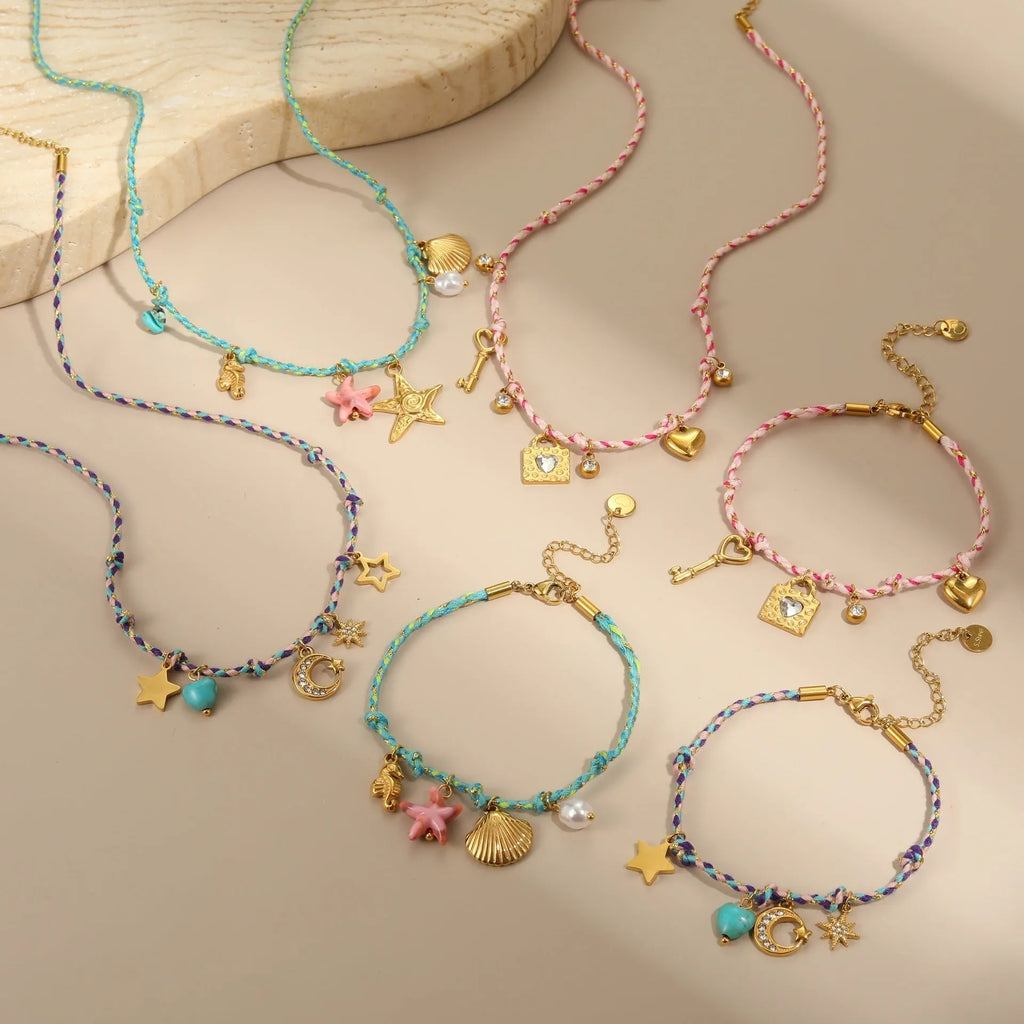 Braided rope chain stainless steel necklace with heart pendant and 18K gold plating on a model.