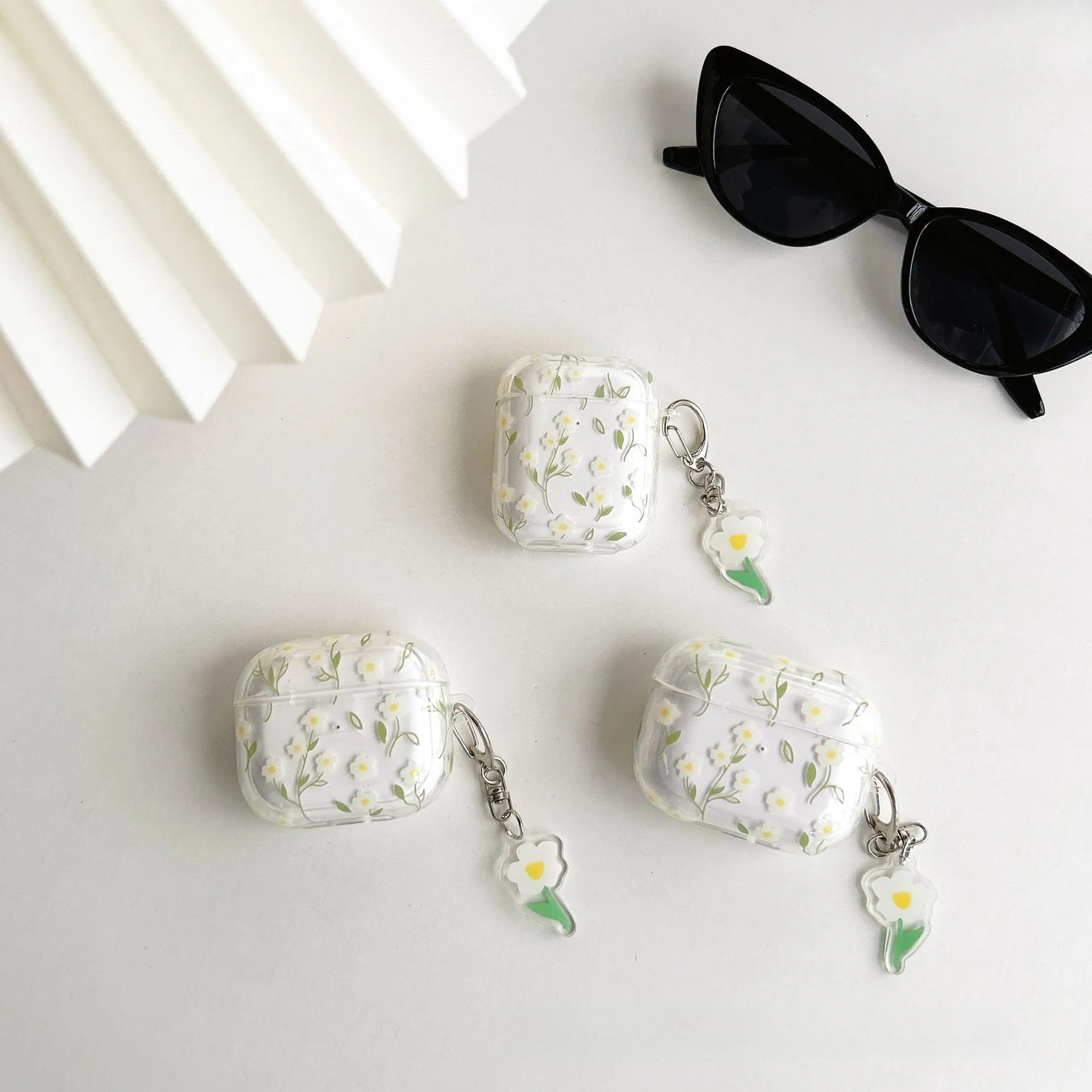 White floral patterned transparent TPU protective cover for Apple AirPods showing compatibility with multiple models
