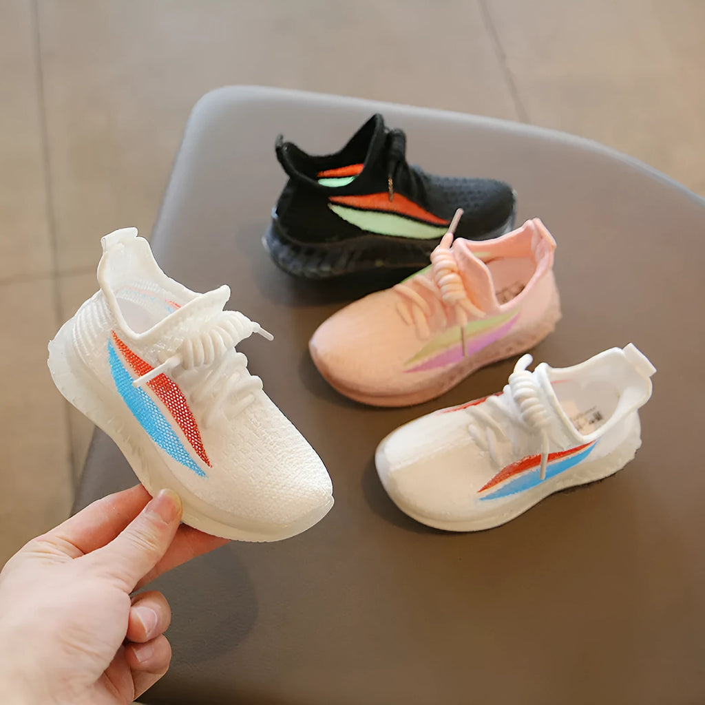 Children's white woven mesh sports shoes with rubber sole, side view on light background