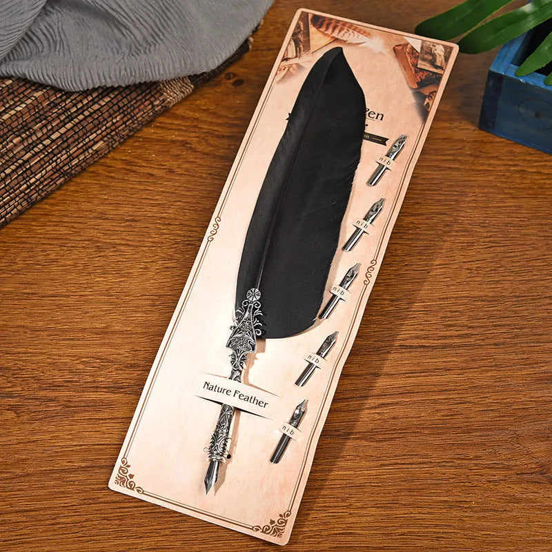 Vintage feather dip pen with zinc alloy body in ten colour options on cardboard packaging.