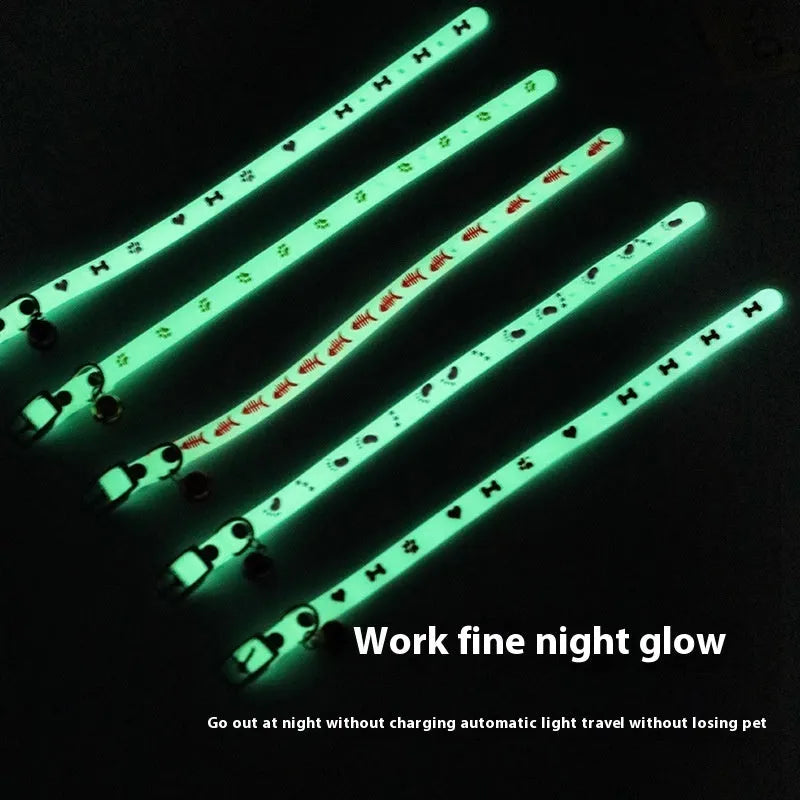 Glow in the dark adjustable silicone cat collar with metal bell in paw print pattern.