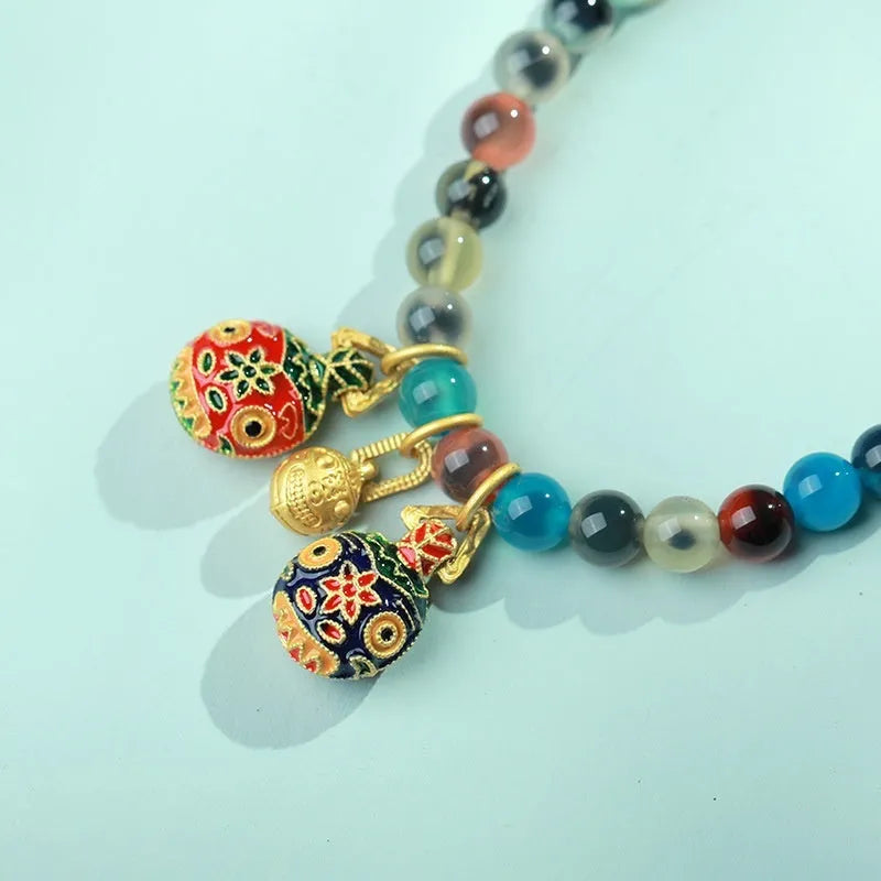 Women's geometric bracelet with colourful sugar heart agate beads and a detailed copper coin snake chain.