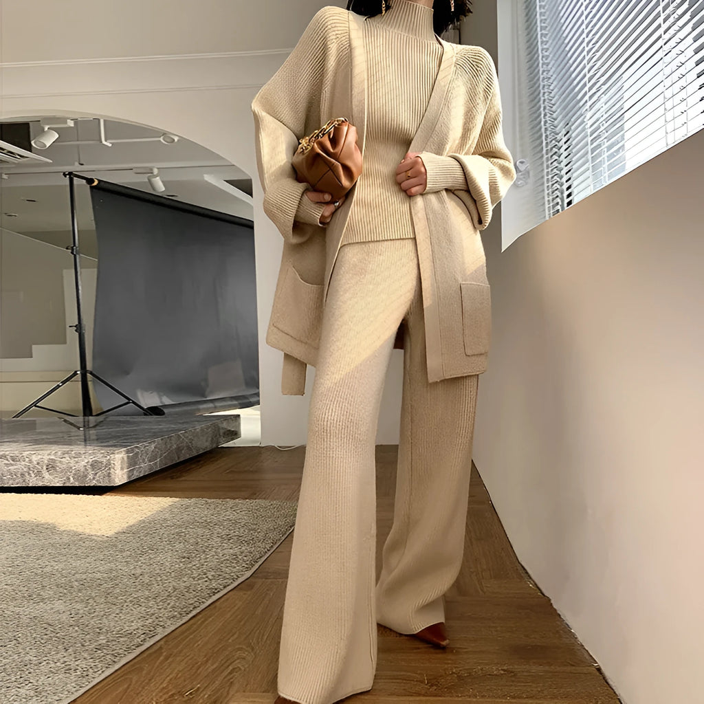 Women's apricot knitted wide-leg pants, sweater and cardigan three-piece set with leather stitching detail.