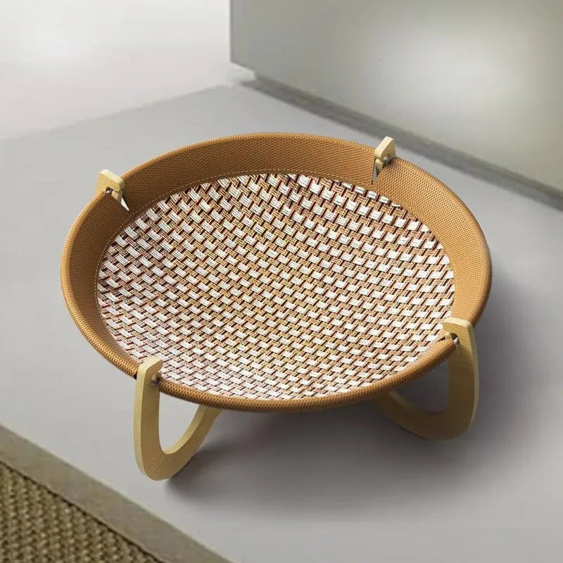 Brown woven rattan square pet bed basket for cats and small dogs on a wooden floor.