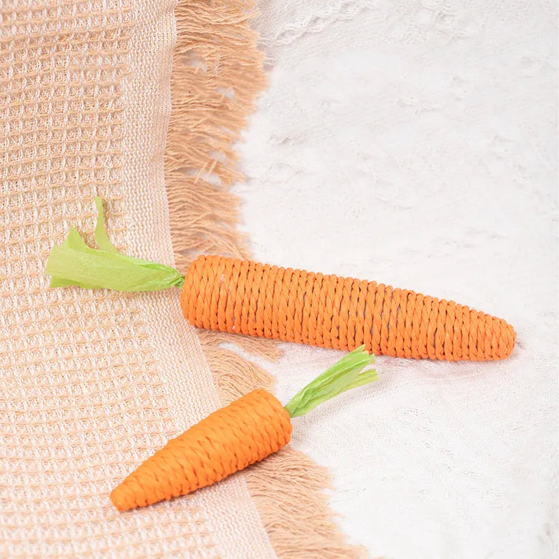 Assortment of cat toys including paper carrot bites, ringing stones, textured sticks and tooth grinding pieces in two sizes