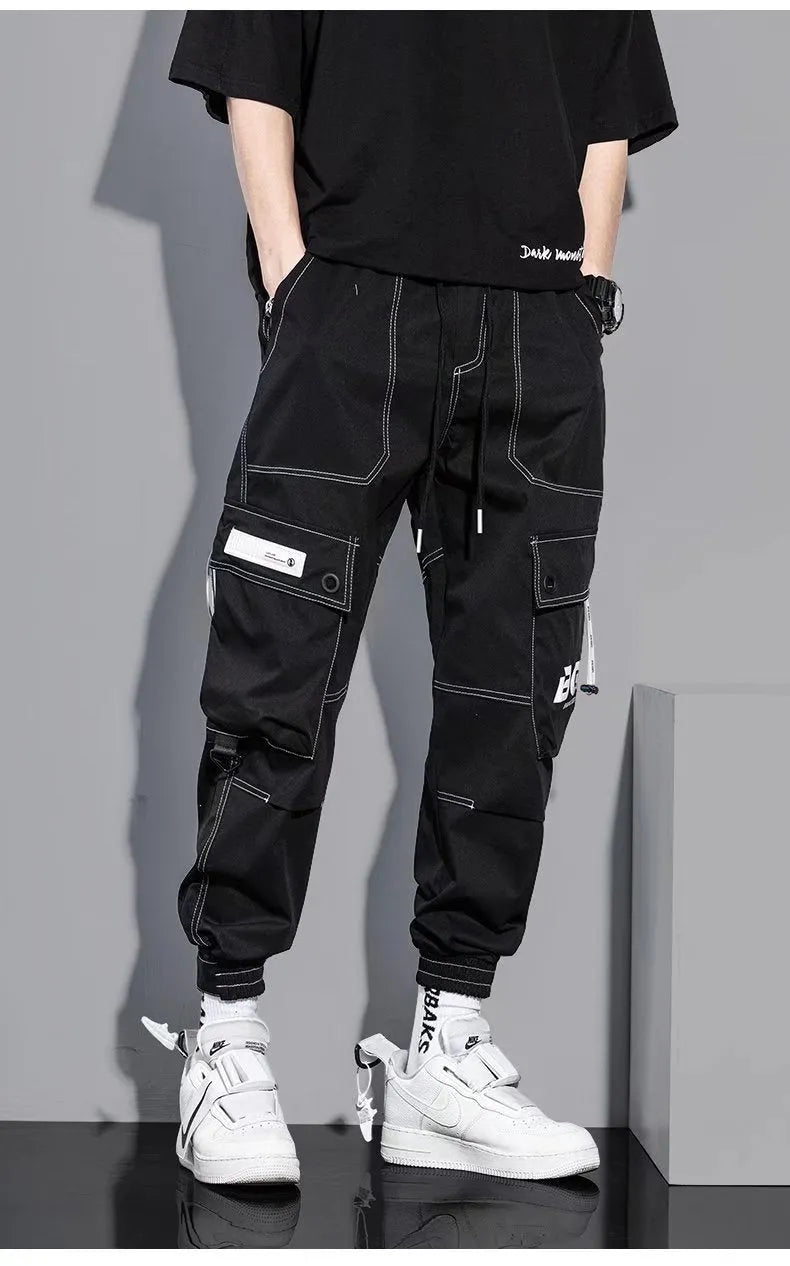 Men's loose fit solid colour polyester trousers in gray, front view, for casual autumn wear