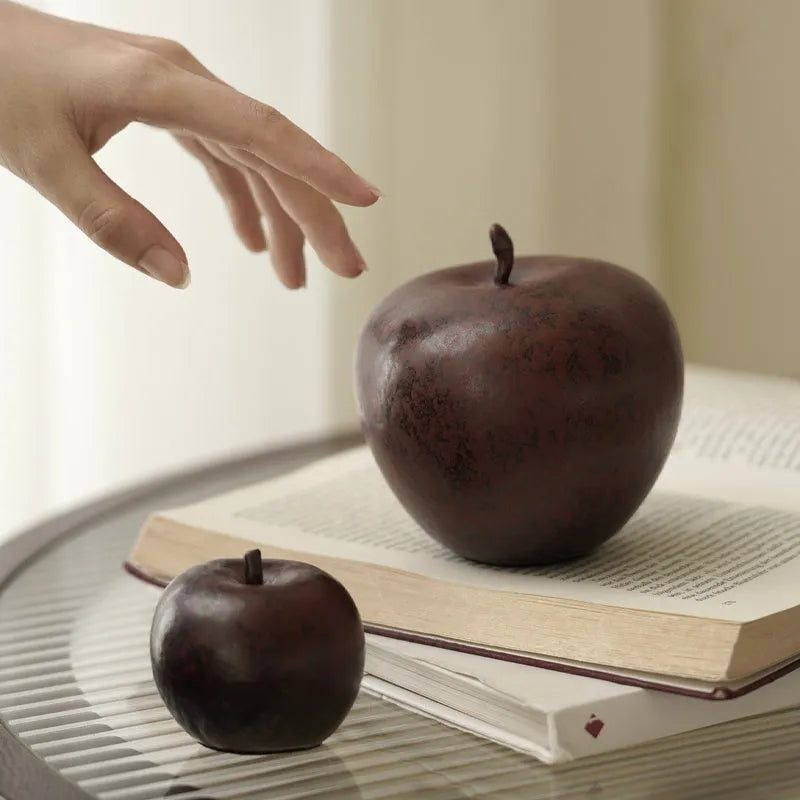 Retro style Chinese ceramic apple decoration ornament on a desktop.