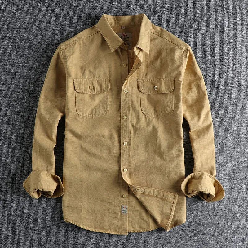 Men's light blue British retro style cotton cardigan shirt with long sleeves on a hanger.