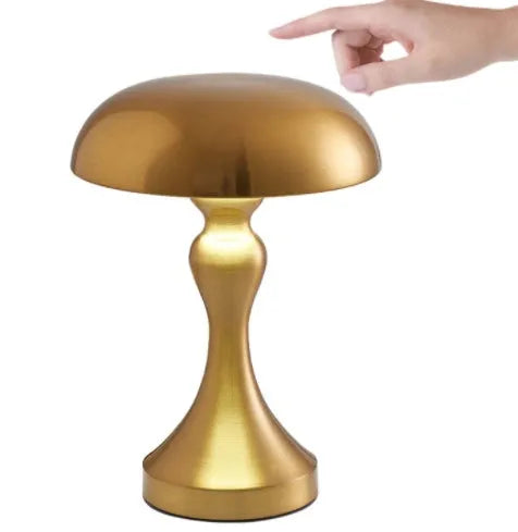 Metallic bronze USB rechargeable LED desk lamp with touch control on a wooden desk