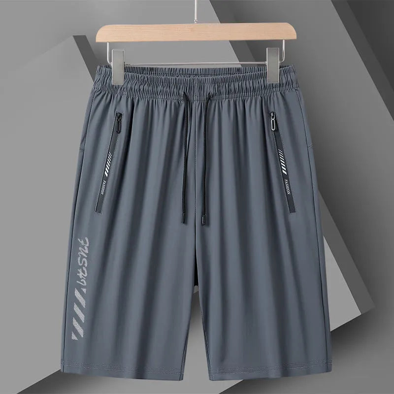 Men's black quick-drying nylon sports shorts with a loose fit and mid-thigh length on a grey background.