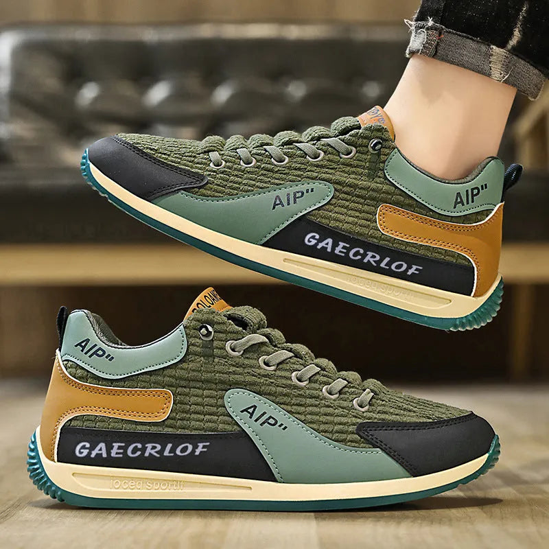 Men's grey mesh running shoes with round toe and lace-up closure on sports surface