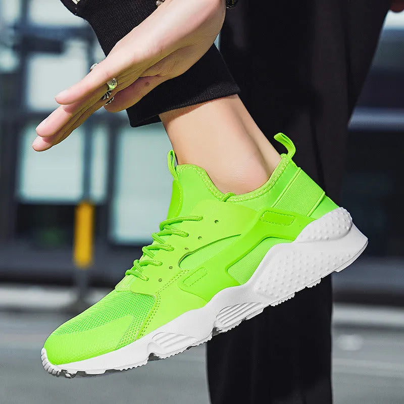 Men's casual low top shoes with mesh upper in fluorescent red colour showing round toe and lace-up design