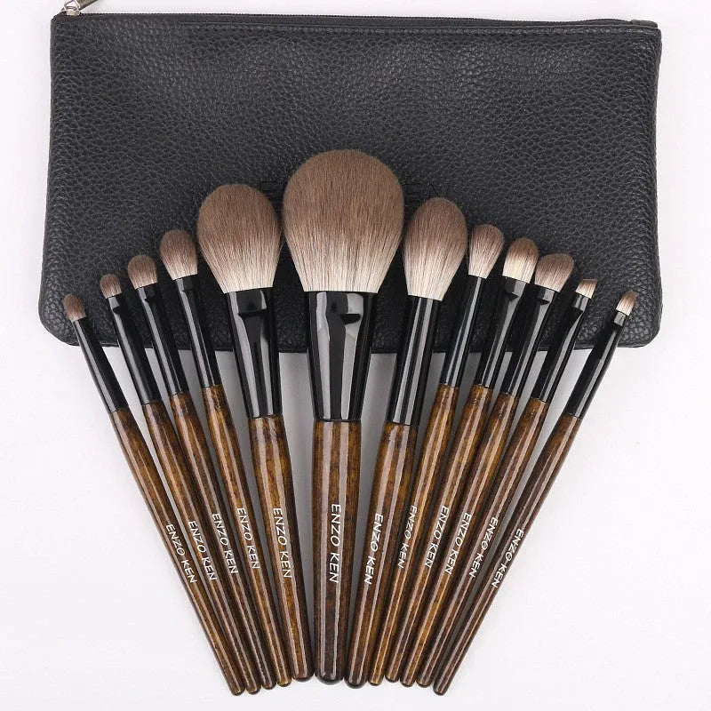 12-piece makeup brush set with wooden handles and a grey PU storage pouch.