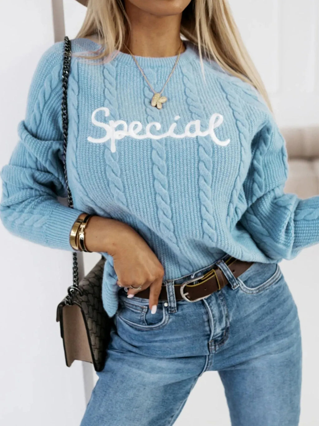 Blue men's pullover sweater with embroidered text pattern on the front, crew neck design.