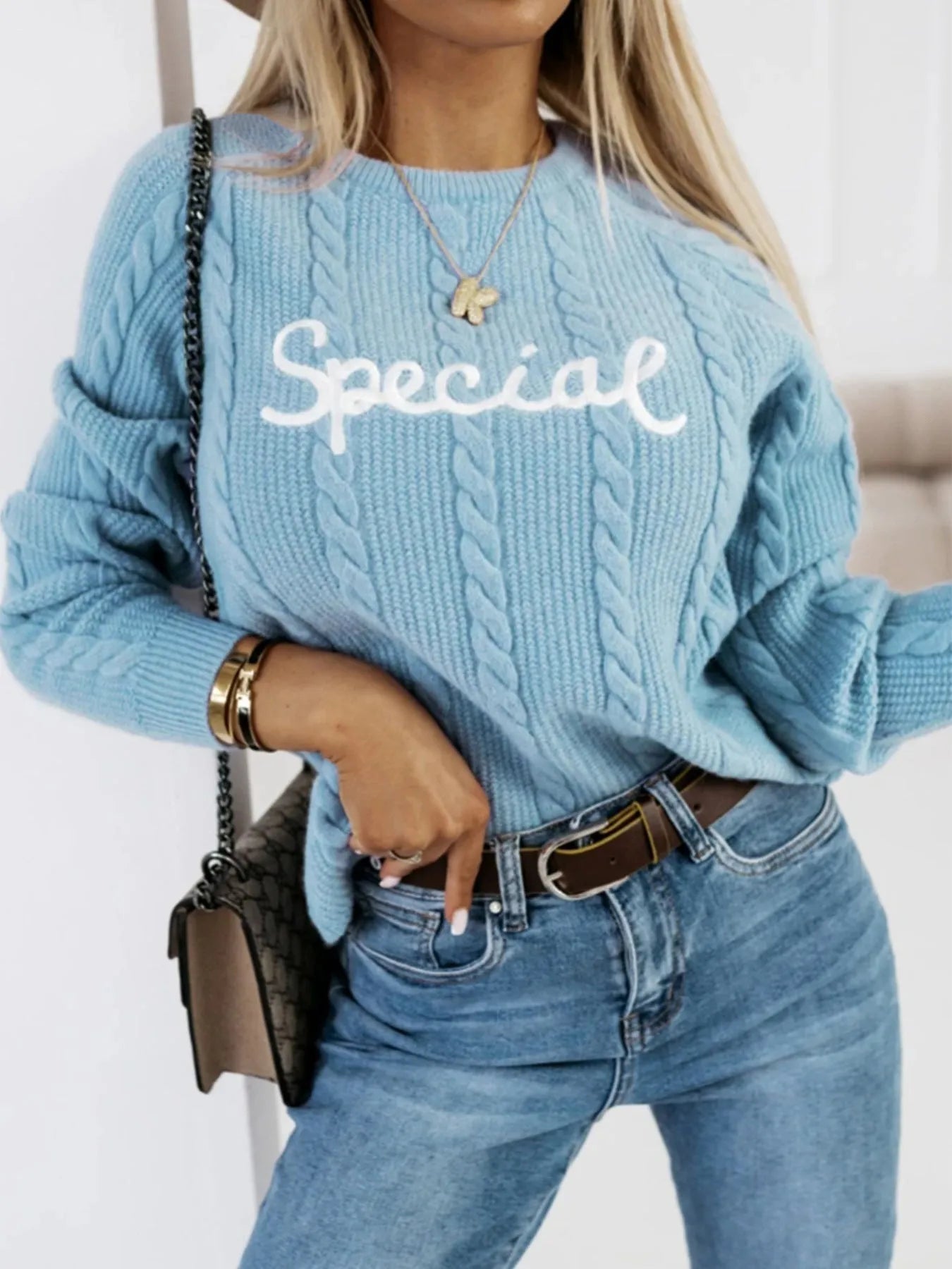Blue men's pullover sweater with embroidered text pattern on the front, crew neck design.