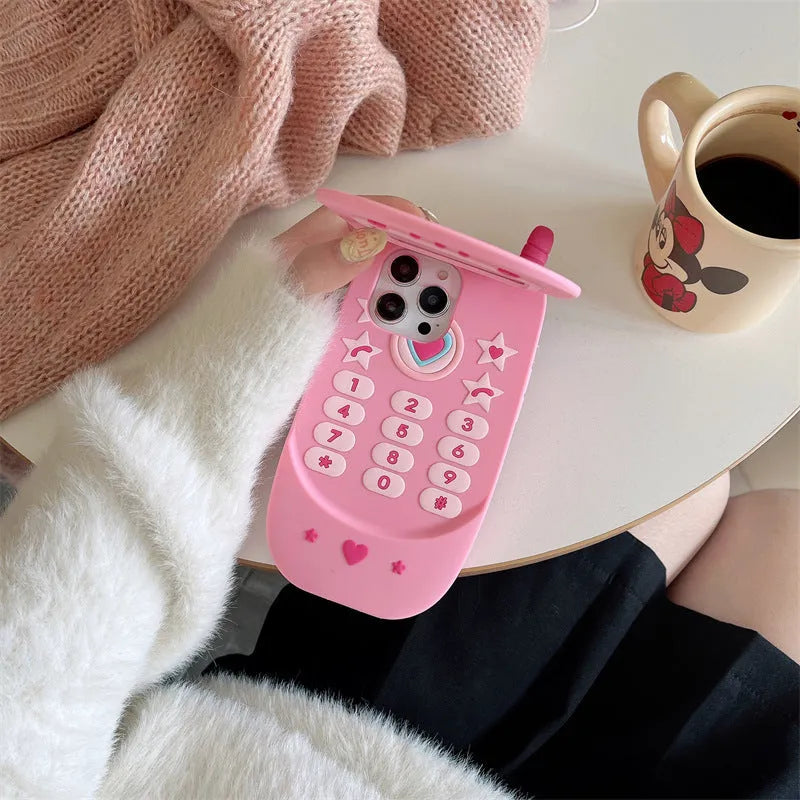Light pink silicone flip phone case with built-in mirror for iPhone, showing cute cartoon design