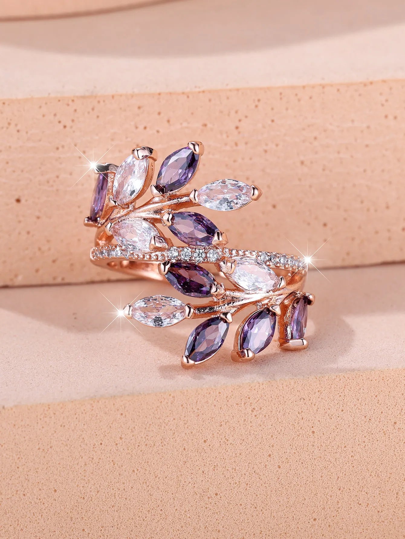 Adjustable horse eye design leaf ring in copper with zircon crystals, shown in a rose gold finish