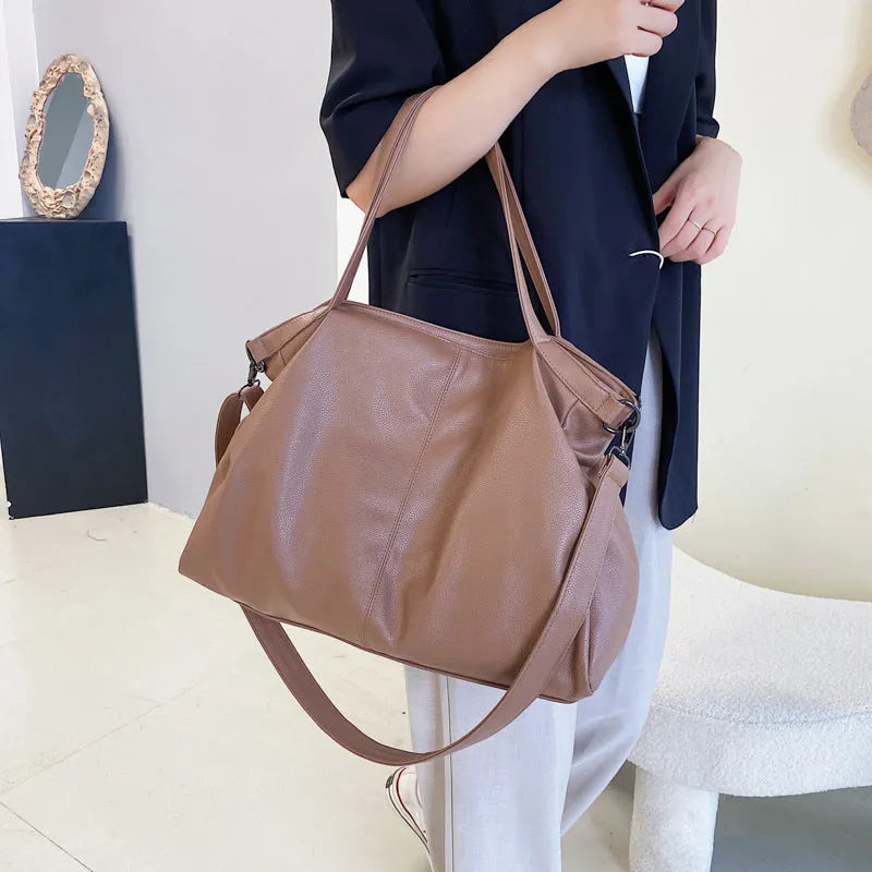 Large soft surface PU messenger bag in a horizontal square tote style with a shoulder strap.