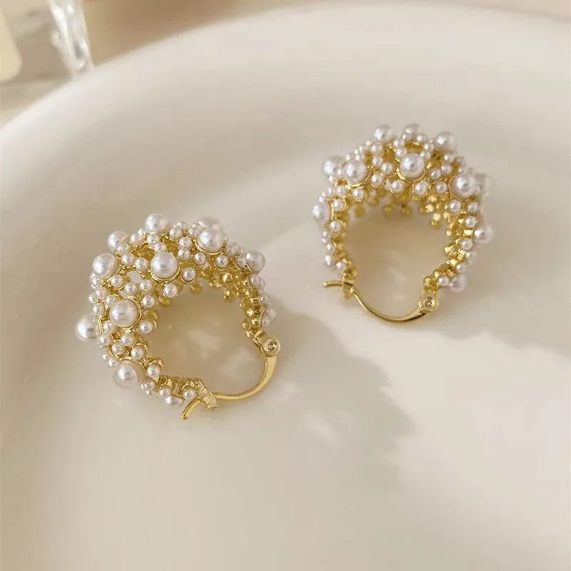 Gold colour women's floral basket design earrings with small beads and pearl inlay on copper