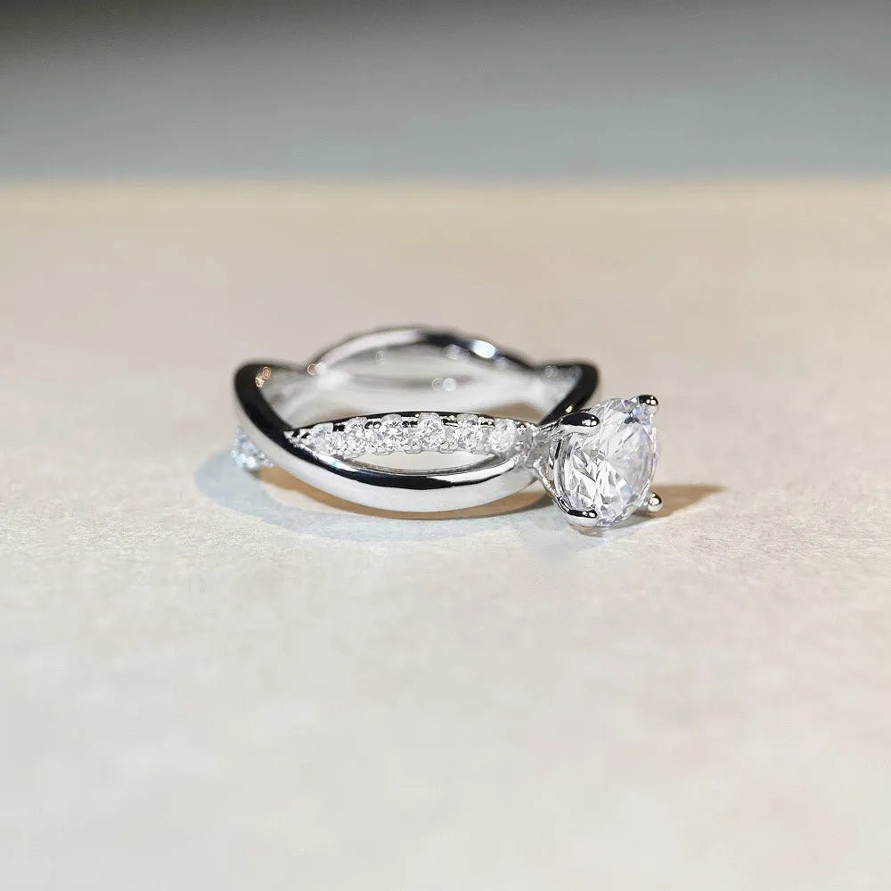 Geometric cross pattern silver ring with 1 karat moissanite stone in twisted arm setting