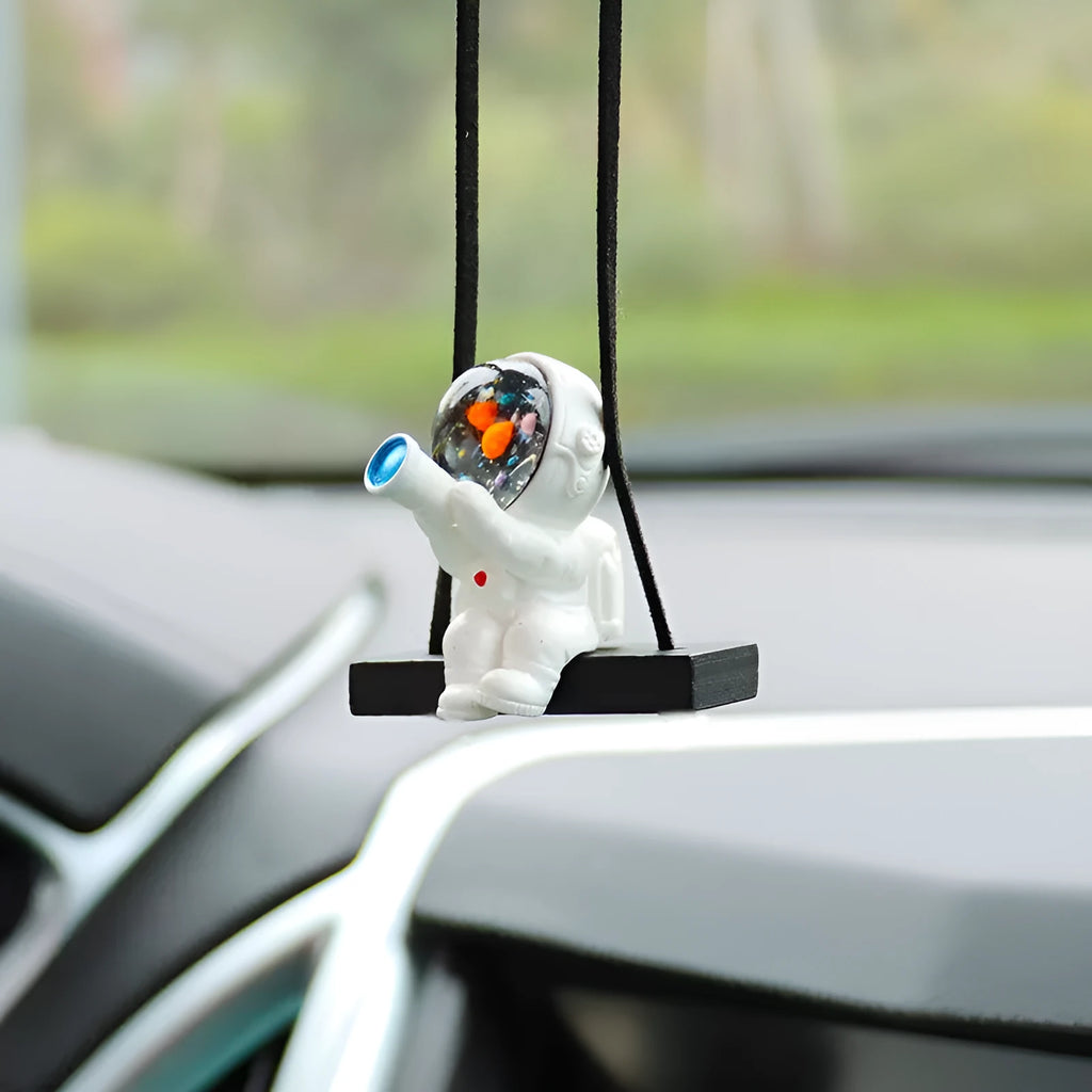 Resin astronaut car pendant with cartoon space explorer designs including telescope and radish variations