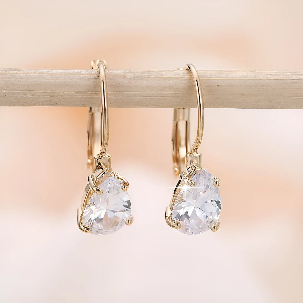 Women's drop-shaped simple metal fashion earrings in gold and platinum colour options.