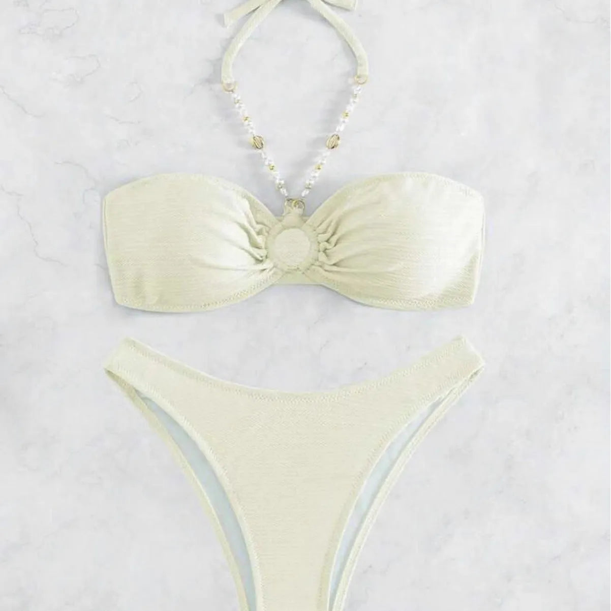 Women's solid colour halter bikini set in creamy-white, shown front-on.