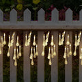 6.5 metre solar LED string lights with bubble drops pendants decorating an outdoor fence