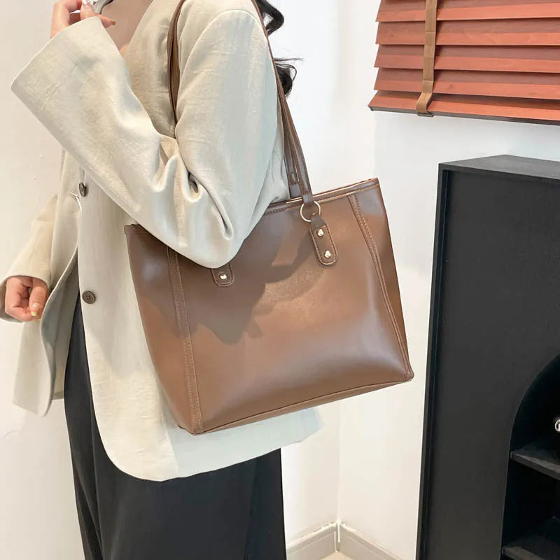 Korean style black PU shoulder underarm bag with a sandwich pocket and horizontal square shape.