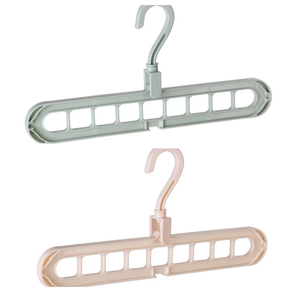 Plastic clothes hanger with rotating hook in pink and green colours on a rail.