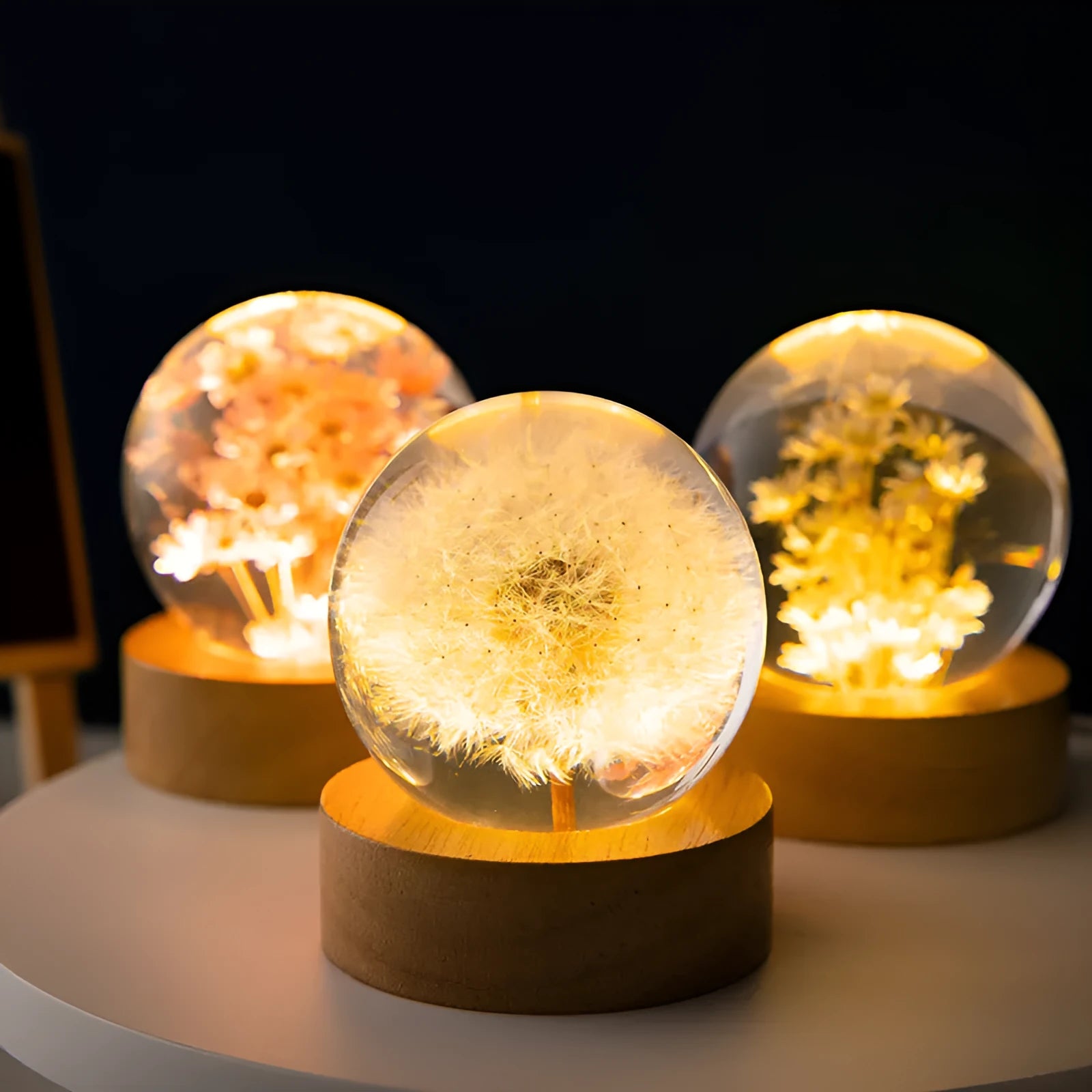 Dandelion crystal ball night light with wooden base, showing preserved flowers inside a 6cm resin sphere.