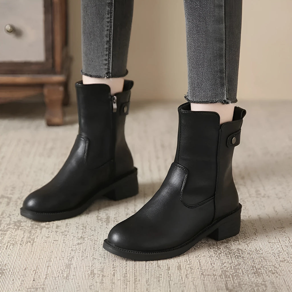 Black women's ankle boots with a side zipper, round toe, and a low rubber sole