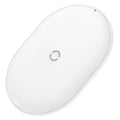 Black Baseus wireless charging pad with a textured surface and a small LED light, next to a mobile phone.