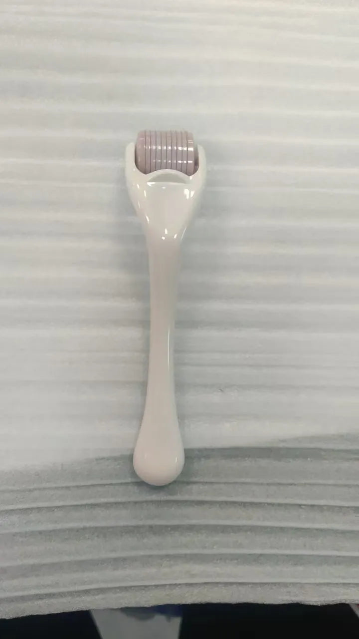 Black handle microneedle roller with purple wheel showing 540 needles, next to white and blue handle options.