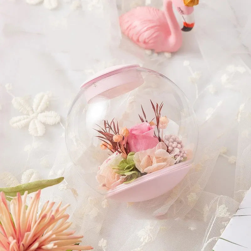 Pink preserved real rose ornament in a decorative case with optional base and Bluetooth speaker.