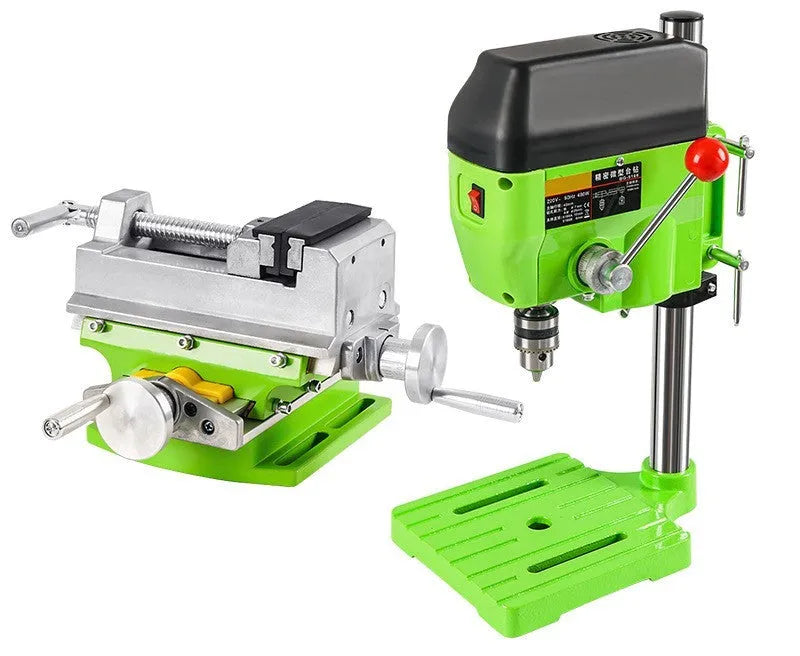 Bench-mounted drilling and milling machine with motor, chuck, and adjustable work table.