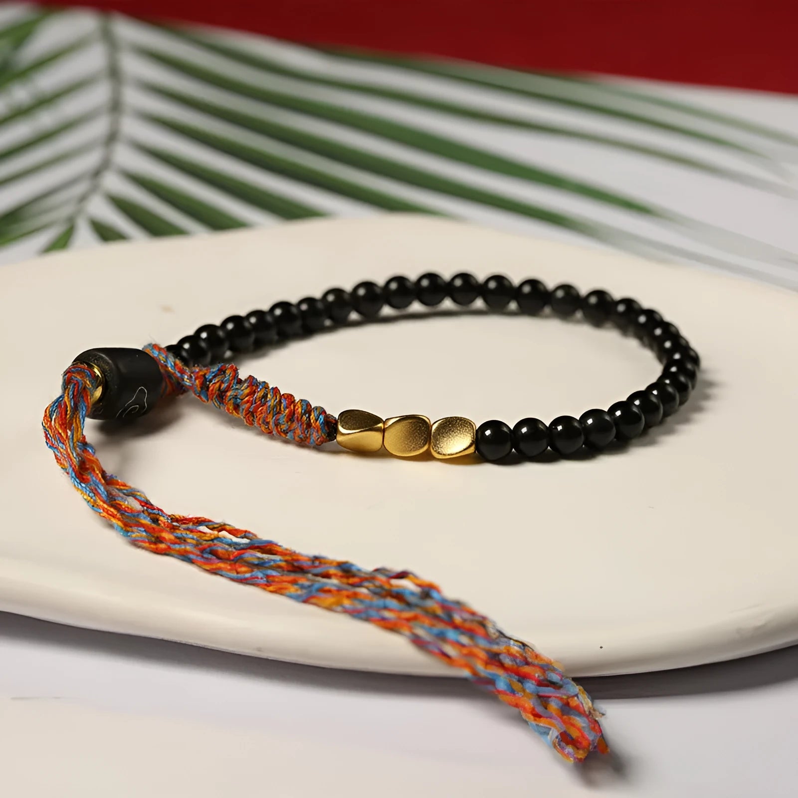 Hand-woven obsidian carrying strap showing 4mm width and adjustable length for phones, keys, or cameras