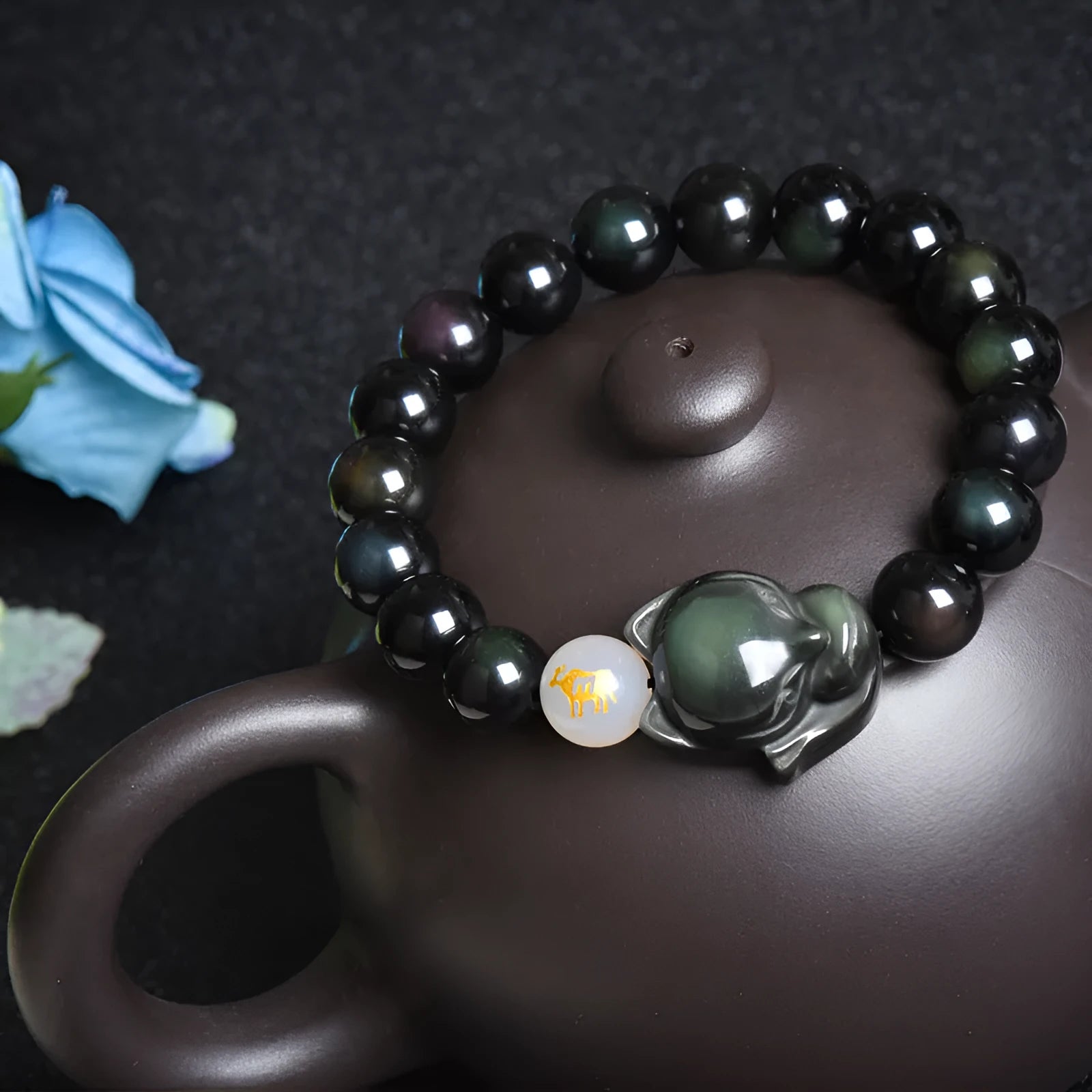 Natural obsidian zodiac guardian bracelet with 10mm beads on an adjustable cord.