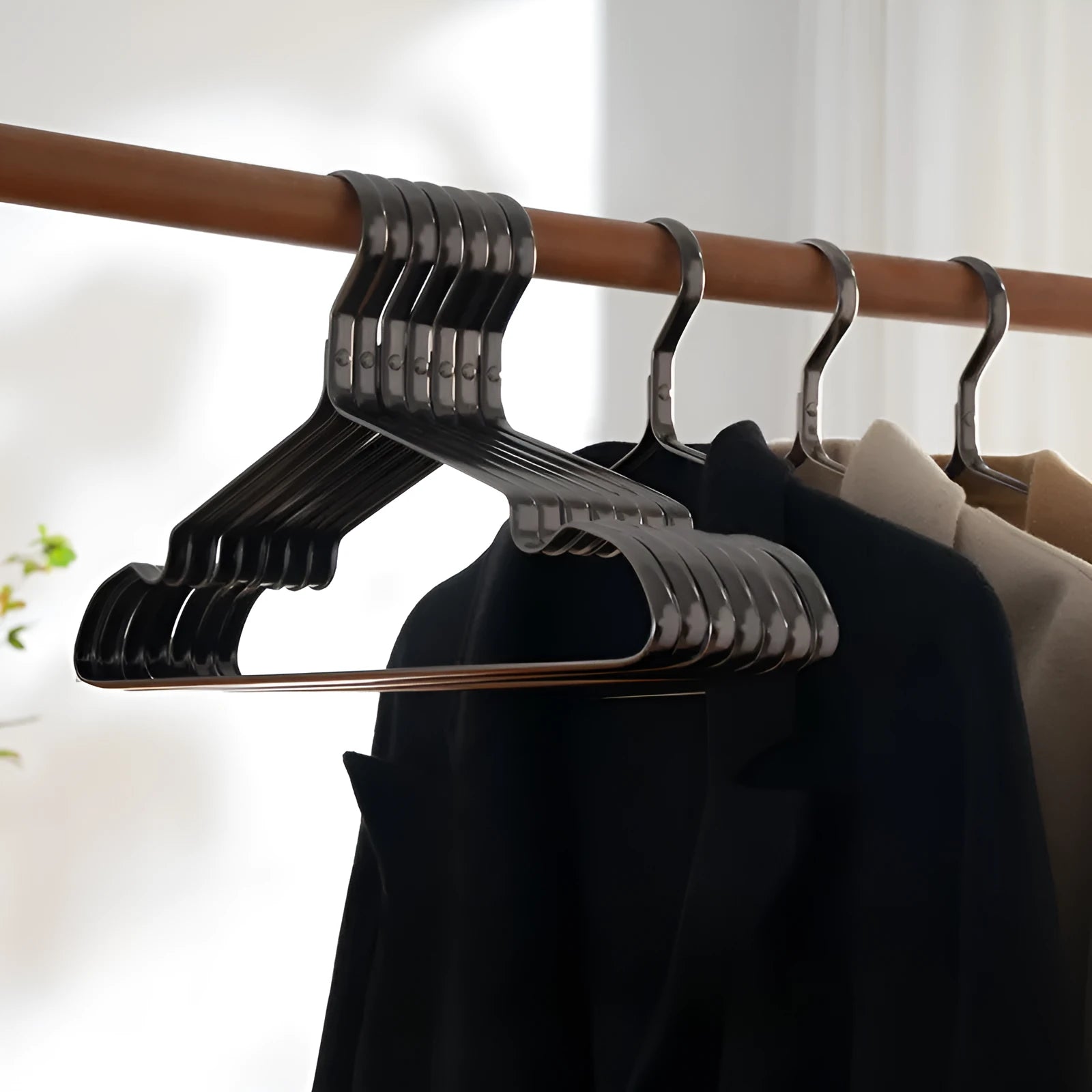 Elegant black modern simple clothes hanger for non-slip anti-rust garment organisation.