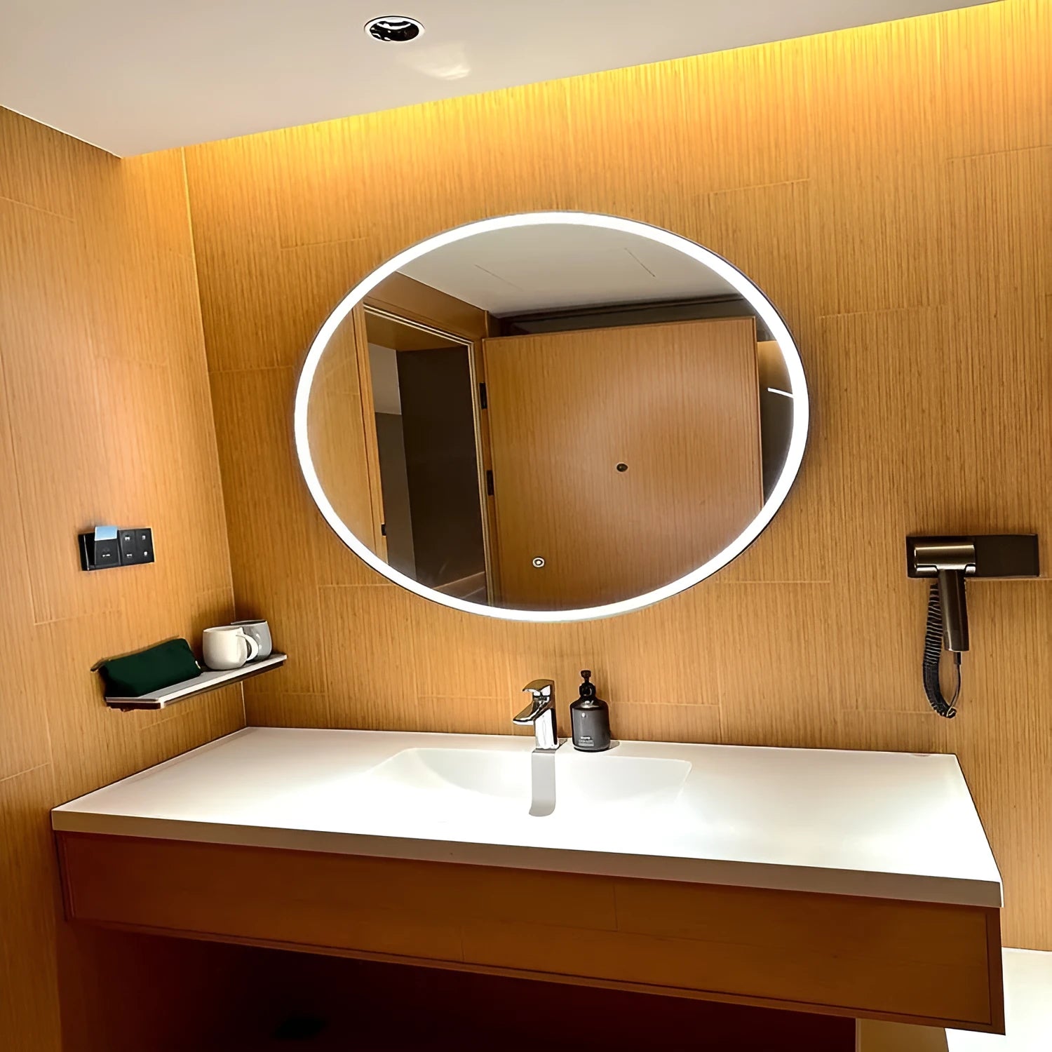 Round smart bathroom mirror with black aluminium frame and integrated LED lighting