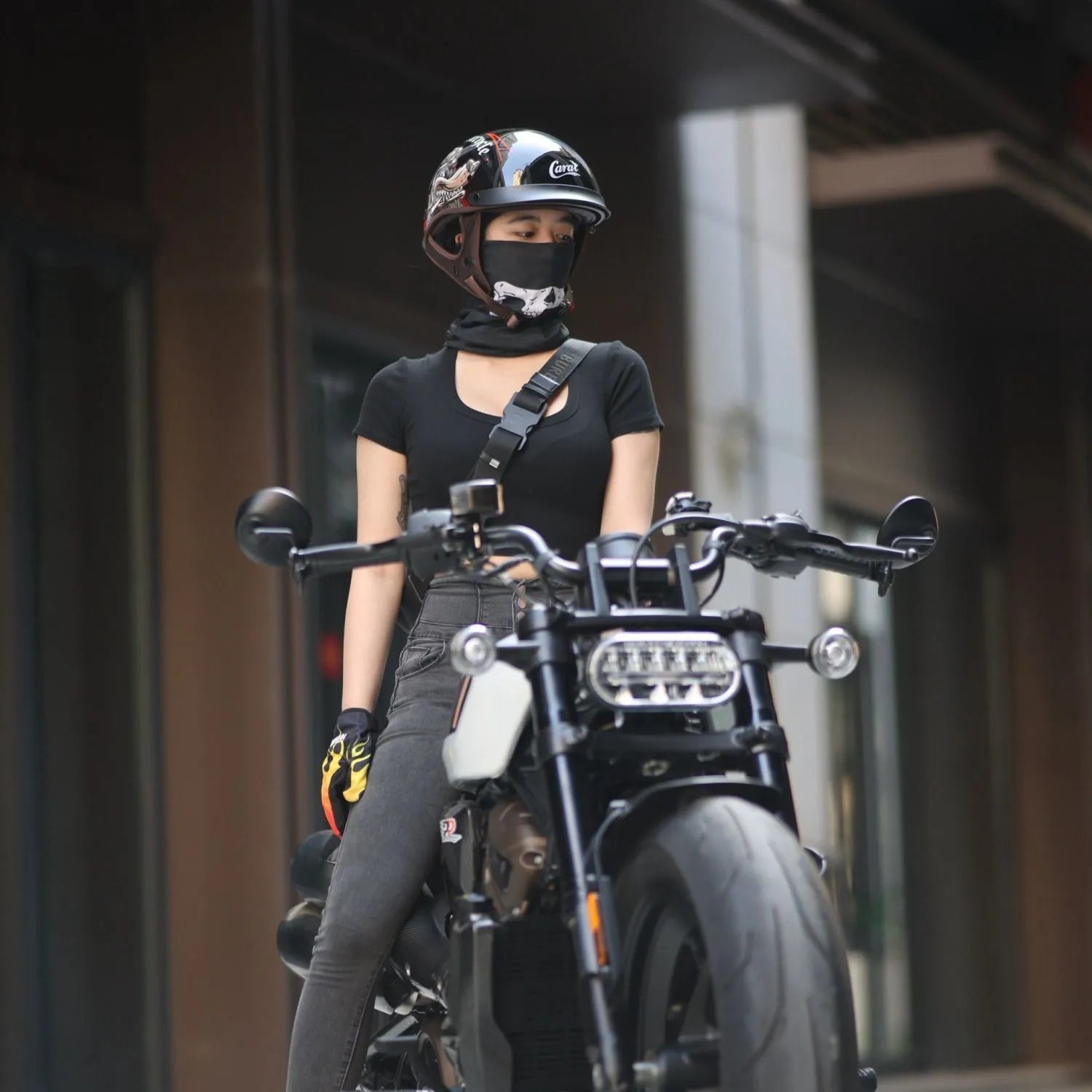 Retro electric motorcycle helmet in matte black with Whirlwind Dog graphic, shown on a rider.