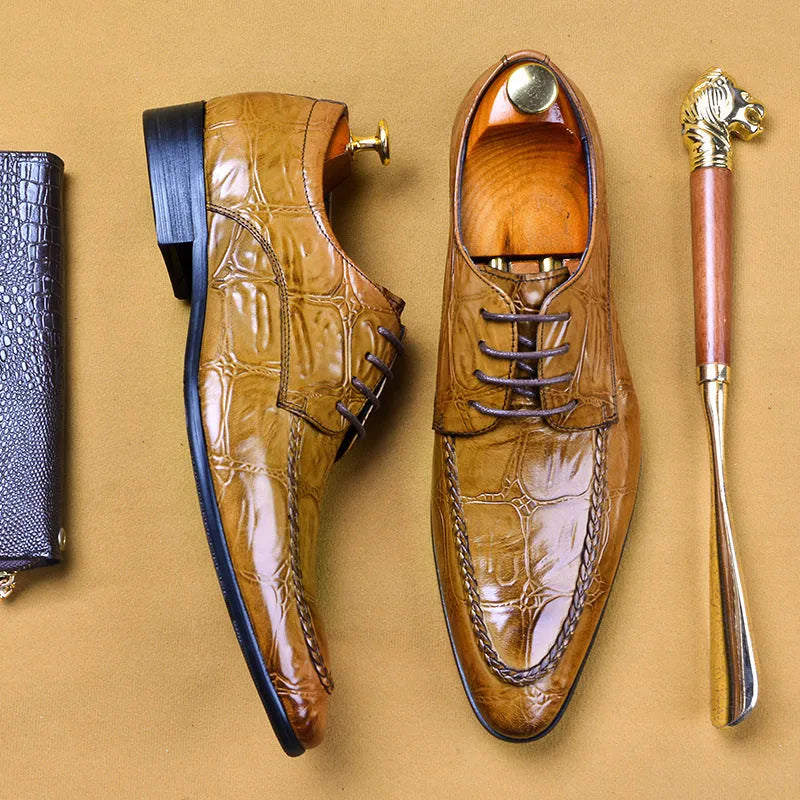 Men's black leather formal shoes with alligator pattern texture and a horse bit buckle detail.