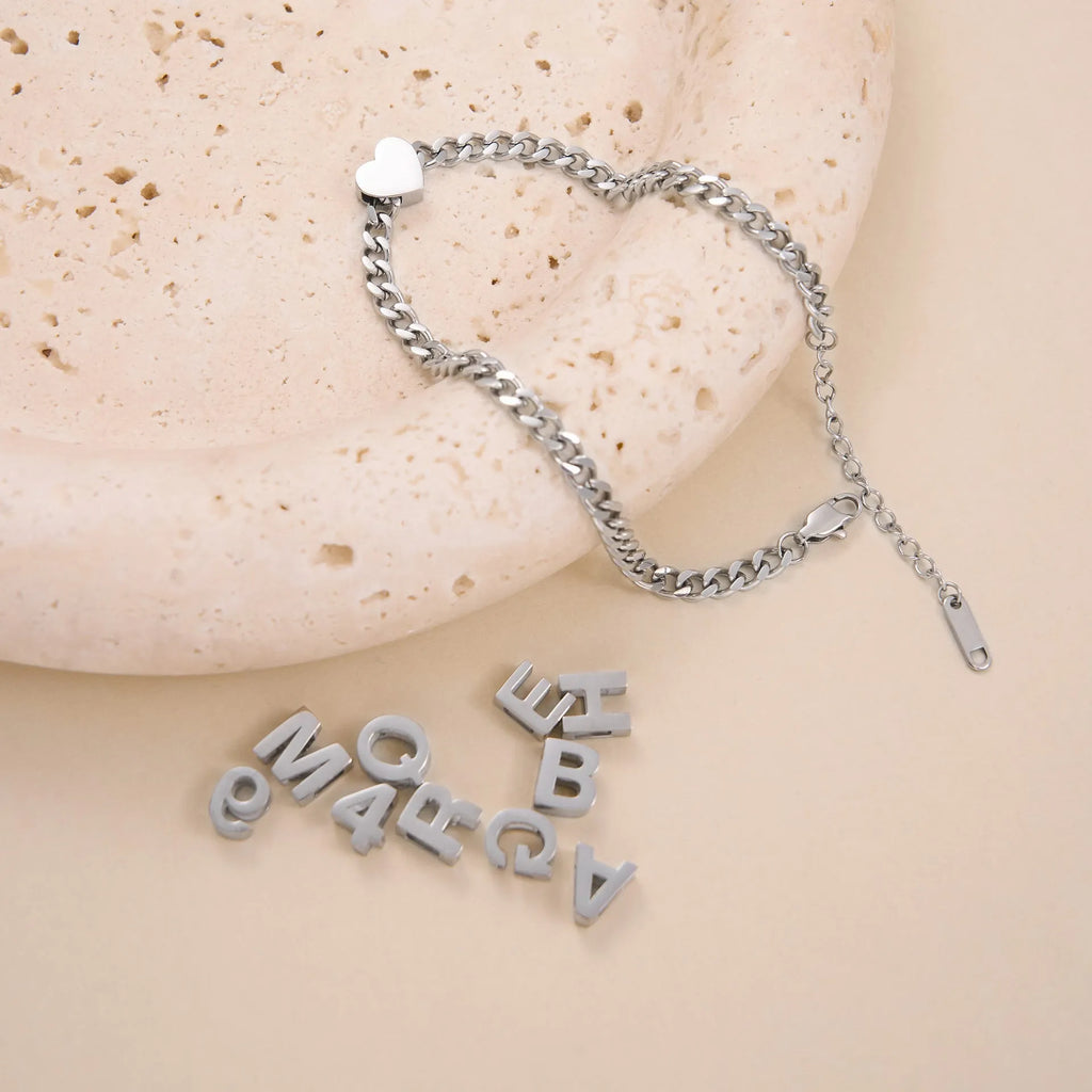Titanium steel necklace with a choice of letter, number, or love heart pendant on a 40.5 cm chain.