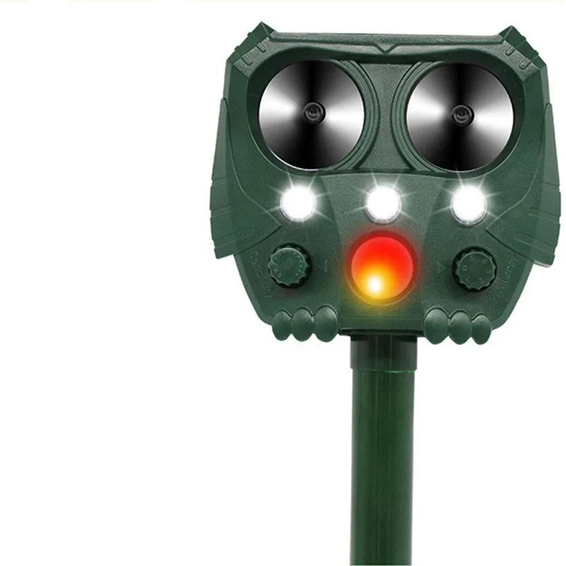 Green solar-powered ultrasonic animal repeller with LED strobe lights for outdoor dog and pest control